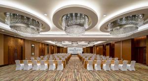 a conference room with rows of chairs and chandeliers at Radisson Collection Hyland Shanghai in Shanghai