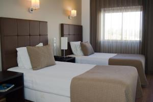 Postel nebo postele na pokoji v ubytování Hotel Paiva