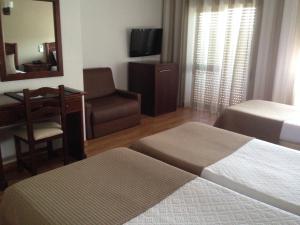 Postel nebo postele na pokoji v ubytování Hotel Paiva