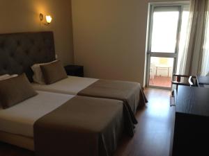 Postel nebo postele na pokoji v ubytování Hotel Paiva