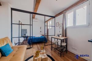 a living room with a couch and a table at LE ZEN Appartement 4 pers CENTRE VILLE in Perpignan