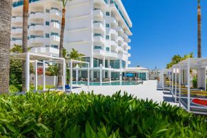 an exterior view of a building with a swimming pool at Tasia Maris Sands (Adults Only) in Ayia Napa