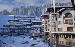 a group of buildings with snow on the ground at Ski-in ski-out Studio 2A7 Grand Monastery in Pamporovo