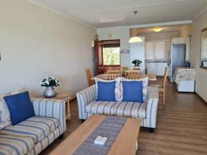 a living room with two couches and a table at Point Village Accommodation - Erin 5 in Mossel Bay