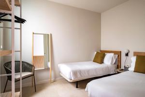 A bed or beds in a room at Aspasios Garden Apartments