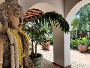 a statue in a courtyard with a plant at VILLA SERENITY 3 Luxury boutique villa in Sant Jordi
