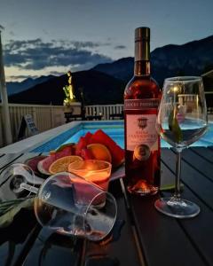 a bottle of wine and a glass on a table at Guesthouse Villa Paškal in Zaostrog