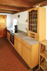 a kitchen with wooden cabinets and a counter top at Holiday Home Backhäusle by Interhome in Unterehlenbogen