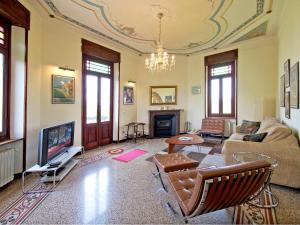 a living room with a couch and a tv at Holiday Home Villa Sarezzano by Interhome in Sarezzano