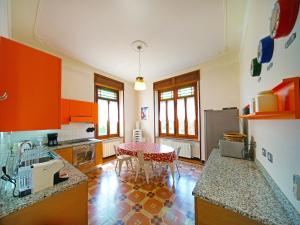 a kitchen with a table in the middle of it at Holiday Home Villa Sarezzano by Interhome in Sarezzano