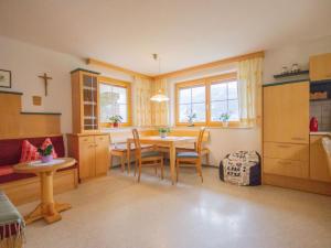 a kitchen and dining room with a table and chairs at Apartment Apart Wolf by Interhome in Fliess