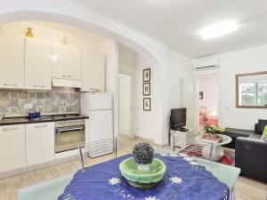 a kitchen and living room with a table in a room at Holiday Home Red Stones by Interhome in Punta Ala