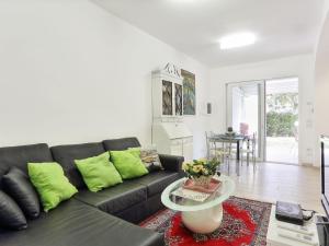 a living room with a black couch and a table at Holiday Home Red Stones by Interhome in Punta Ala