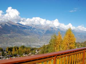 a view of a mountain range from a balcony at Chalet Chalet Boucaro by Interhome in Nendaz