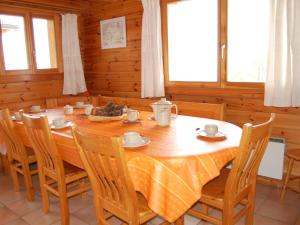 a dining room with a wooden table and chairs at Chalet Chalet Boucaro by Interhome in Nendaz +31 photos