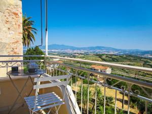 a white chair sitting on a balcony with a view at Apartment Agave by Interhome in Civitella Marittima