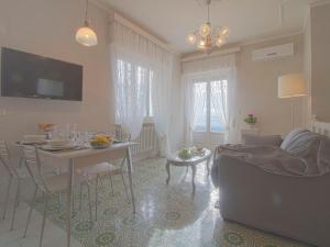a living room with a table and a couch at Apartment Agave by Interhome in Civitella Marittima