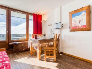 a dining room with a table and chairs and a window at Apartment Grandes Platières II-22 by Interhome in Tignes