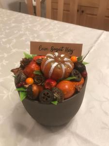 a bowl of fruits and vegetables on a table at Casa Bogát Ház in Harghita-Băi