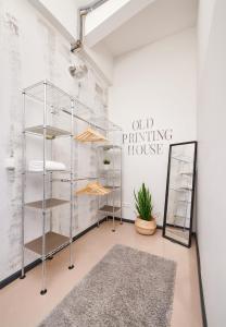 a dressing room with glass shelves and a mirror at Old Printing House in Hannover