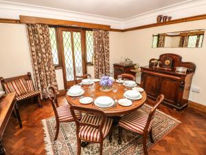 a dining room with a wooden table and chairs at Longsdon in Haverfordwest