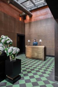 a man sitting at a reception desk in a lobby at Root Karaköy in Istanbul