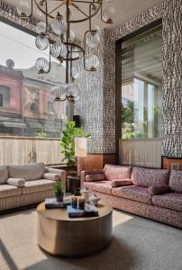 a living room with couches and a coffee table at Root Karaköy in Istanbul