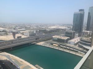 a view of a city with a river and buildings at Royal Club By RVHR, Noora Tower, Al Habtoor City, Business Bay in Dubai