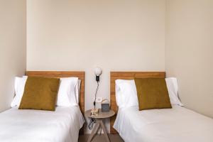 A bed or beds in a room at Aspasios Garden Apartments