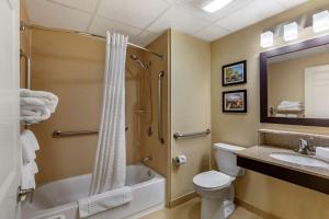 a bathroom with a toilet a sink and a bathtub at Comfort Inn Rockland - Boston in Rockland