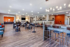a restaurant with chairs and tables and a bar at Sleep Inn & Suites Lancaster-Platteville in Lancaster