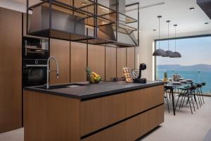 a kitchen with a counter with a sink and a table at Villa Bura in Marusici 