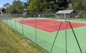 a tennis court with a net on a tennis court at Glynns at Club Correze in Meymac