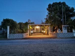 a front entrance to a house at night at Country House in Sozopoli
