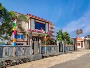 a building with flags in front of it at Collection O 90564 Hotel Merangin Syariah in Bangko