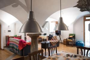 a living room with two hanging lamps and a table at Sci e montagna vera in Pragelato