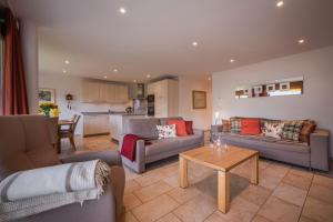 a living room with two couches and a table at Chalet Am Acher 3 in Wengen