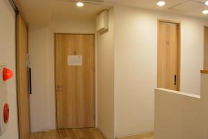 a hallway with a wooden door in a room at 04 village Namba - Vacation STAY 17857v in Osaka