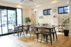 a dining room with tables and chairs and a clock at 04 village Namba - Vacation STAY 17857v in Osaka