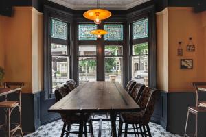 a dining room with a wooden table and chairs at Pontcanna Inn in Cardiff