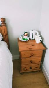 a dresser with a toaster and a plate of food on it at Sailing's Island Rooms in Inisheer +19 photos