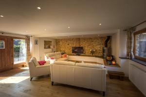 a living room with a white couch and a tv at Apple Tree Barn in Trull