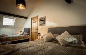 a bedroom with a bed and a tv on the wall at Apple Tree Barn in Trull