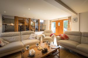 a living room with a couch and a table at Apple Tree Barn in Trull