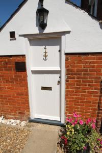 a white garage door with a ship on it at The Old Schoolhouse in Whitstable