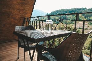 a table with glasses on top of a balcony at Dom Adonis in Dilijan