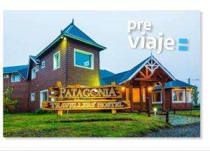 a house with a sign on the front of it at Patagonia Hostel in El Chalten