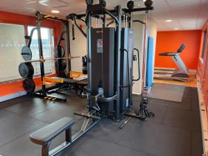 a gym with several treadmills and machines at Motel L Lund in Lund