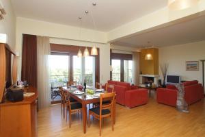 sala de estar con mesa de comedor y sala de estar en Villa Adelais, en Tsoukaladhes