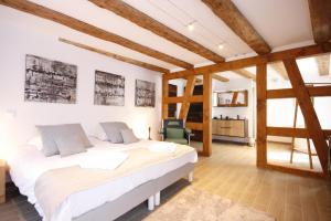 a bedroom with two beds in a room with wooden ceilings at App'Art - Le T avec Sauna in Kaysersberg